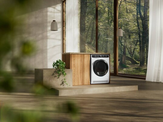 Tumble dryer in a spacious minimalistic room.